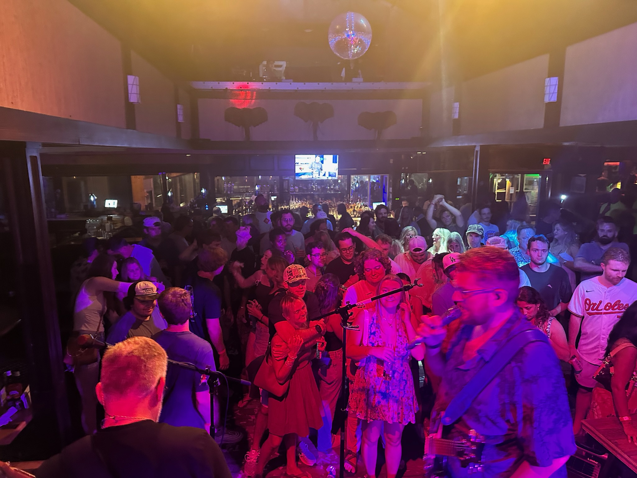 The Chucks facing a packed club crowd under red and purple lights