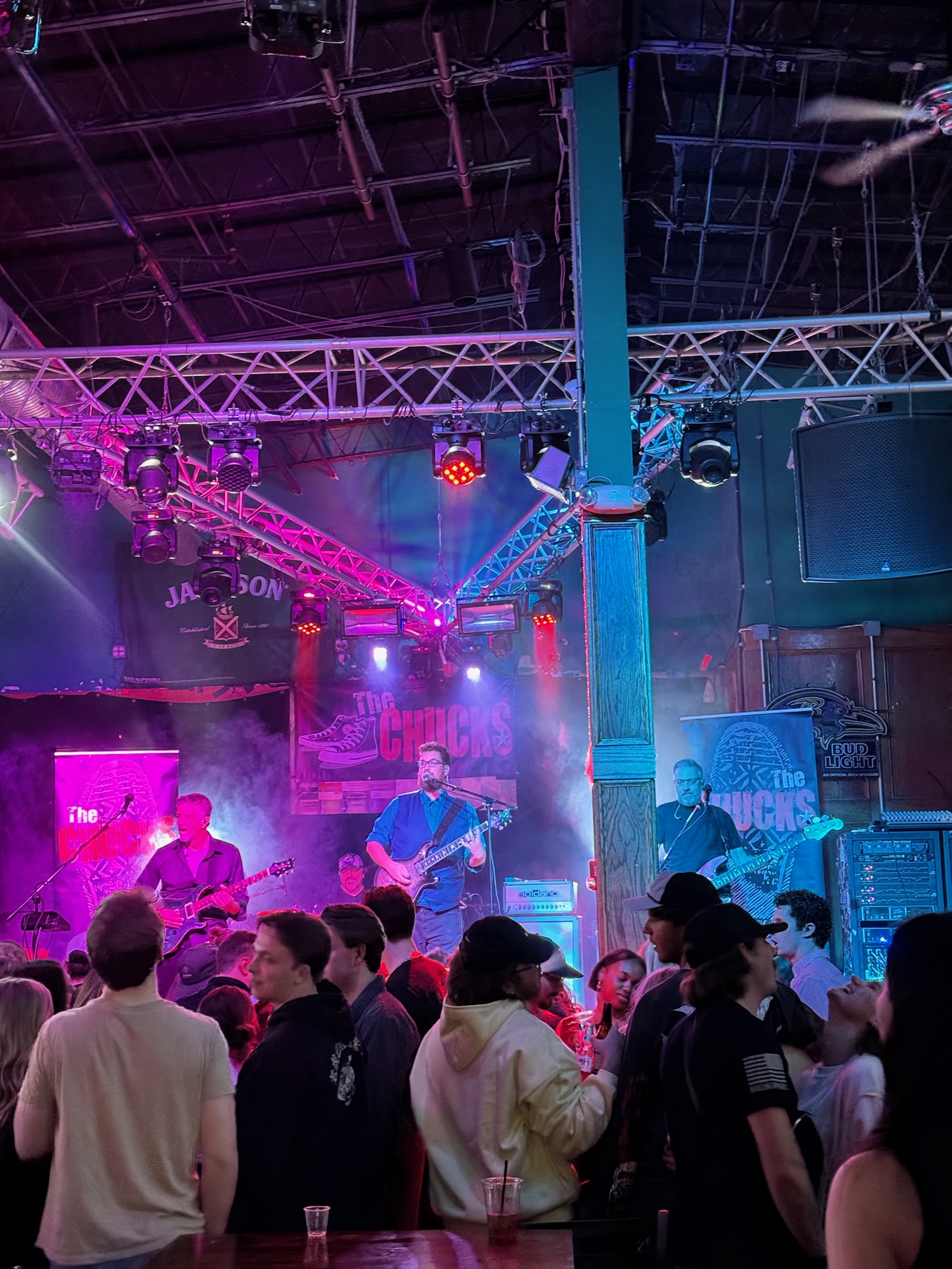 The full band performing through haze and colorful lights at The Jetty