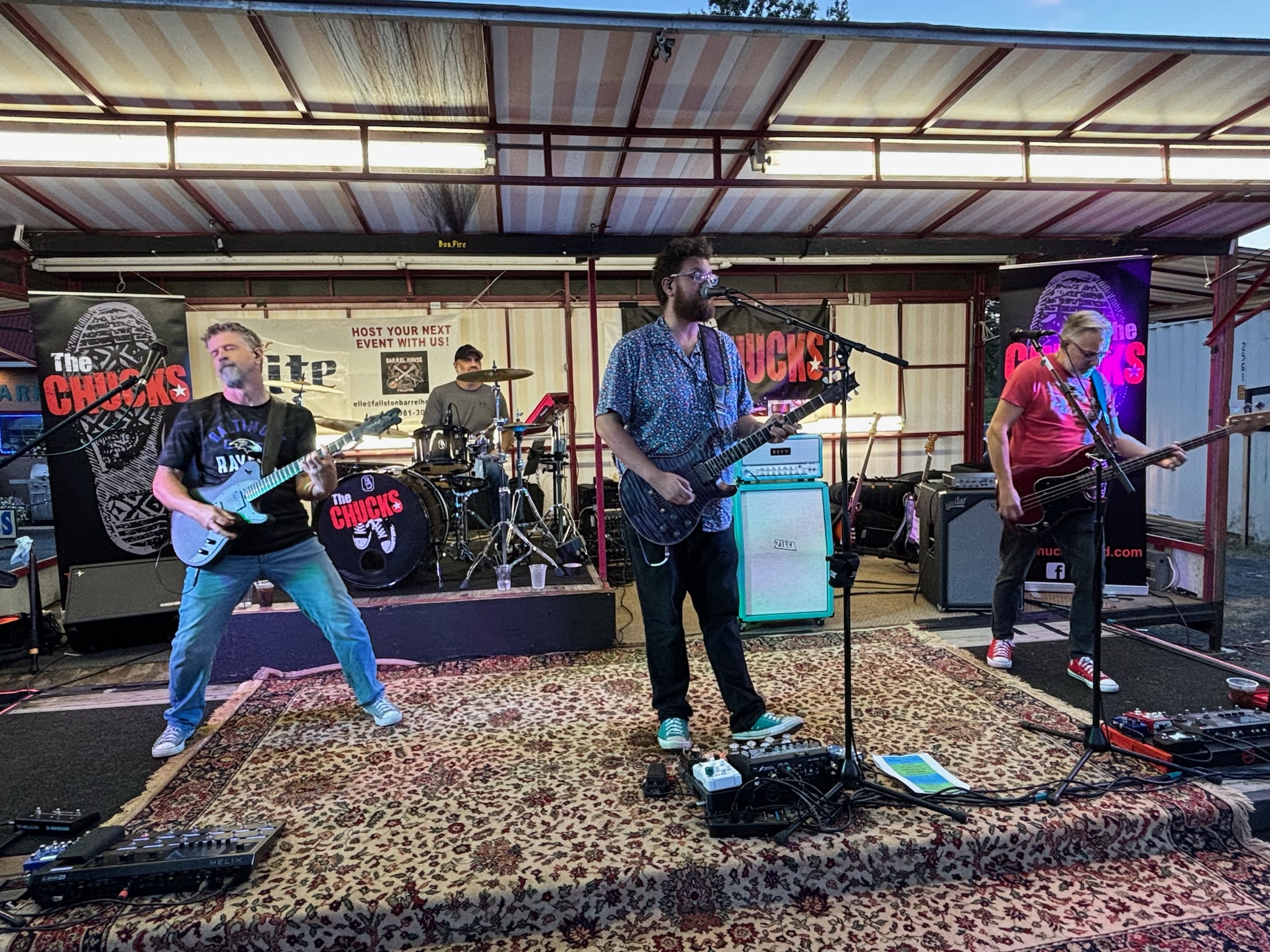 The full band in motion on an outdoor stage